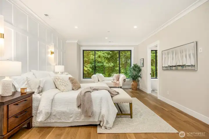 Luxurious primary suite with incredible views of the gloriously lush backyard.