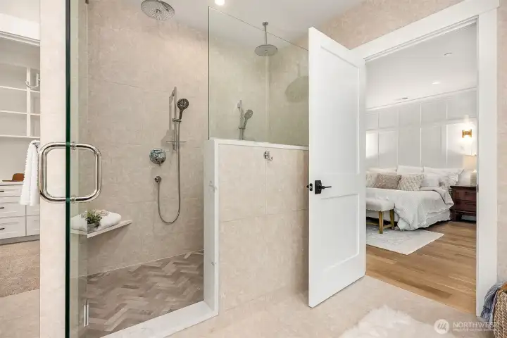 Oversized walk-in shower with 4 shower heads, heated floors and a soaking tub.