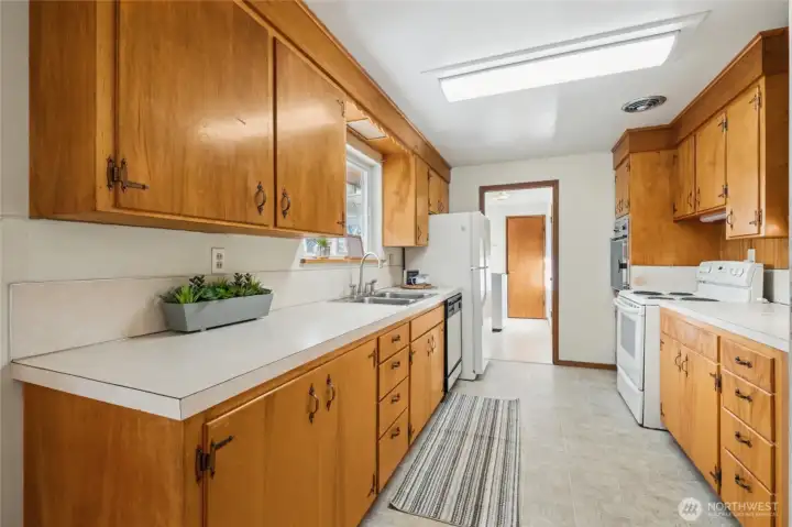 Step in to this "vintage" well-cared for kitchen. Tons of counter space and a window over the sink to look out to the backyard.