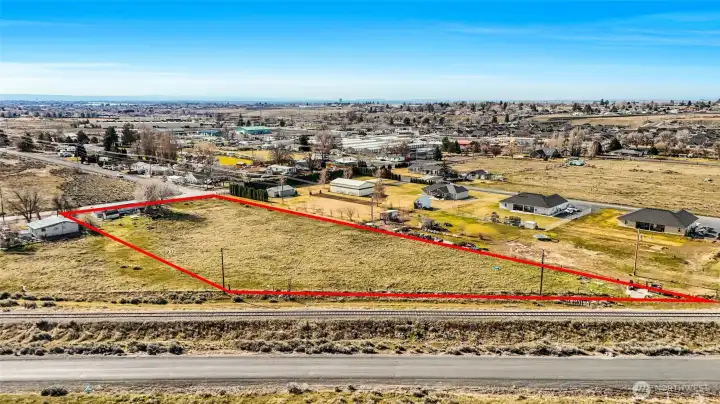 RR tracks border this side of the property. Maple Drive is at the front. The house right next door is occupied and not part of the vacant land listing.