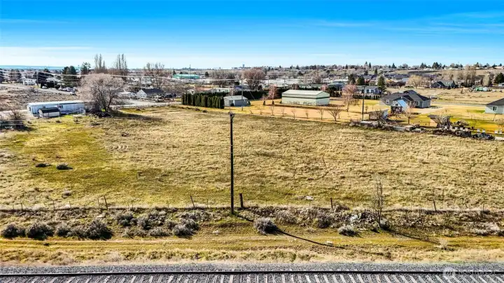 As you can see, this 2.27 acres of vacant land is on level ground. It's a few blocks from Longview Elementary School and is mostly fully fenced, has electricity at the front of the property, and has a septic tank.