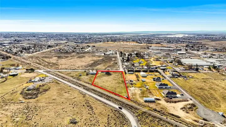 Another view of the property, level, ready for you to get your permits and build on it since it has electricity and septic.  Needs a well but has a possibility of a shared well with home right next door. The house right next door is occupied and not part of the vacant land listing. (Please don't knock on the door of the tenant's home next door.)