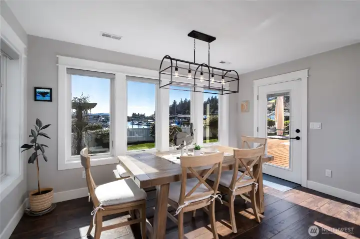 Dining area with views of the water, and door to back deck