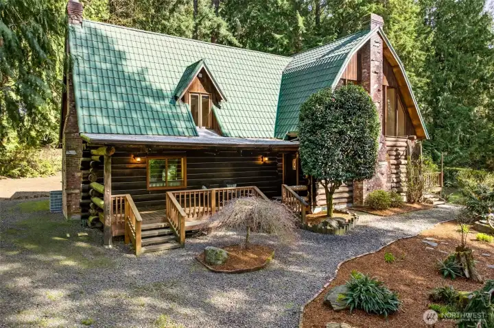 The covered front entry and wraparound deck welcome you home with warmth and character, framed by mature landscaping and the quiet seclusion of 3.71 private acres in Woodinville.