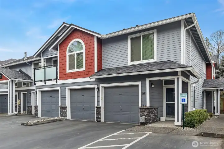 The front door to this unit is to the far right side of this photo.  Side entrance  flows into this wonderful single story condo.  There are two garage doors leading into the attached 2 car garage. This allows for direct access into the home for safety and unloading the cars.