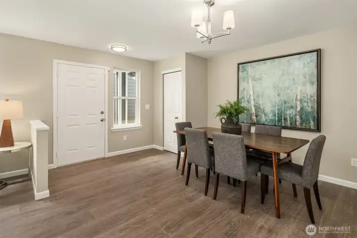 The front door entry, coat closet, and dining area.