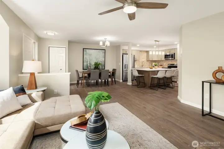 A nice view from the living room back into the dining room and kitchen. Notice the new ceiling fan!
