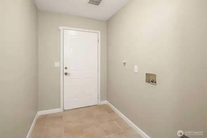 Big Laundry Rm just inside the Garage Door. Hook Ups for Full Size Washer & Dryer. Tiled Floor.