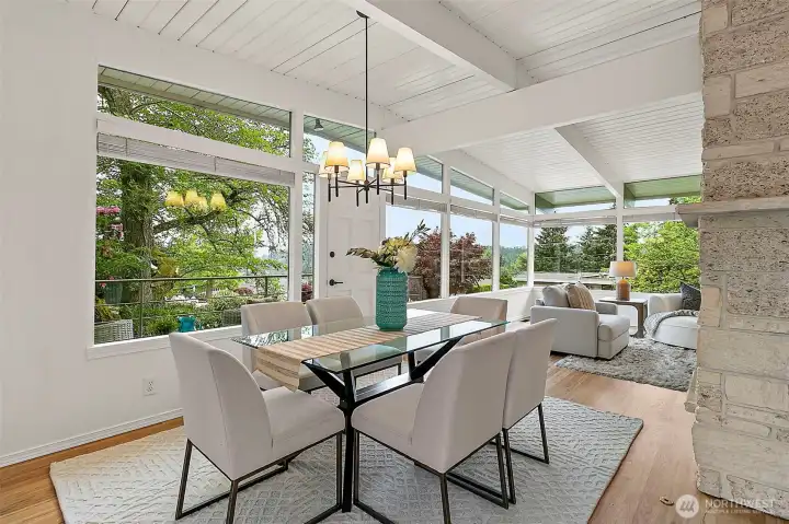 Expansive windows frame lush surroundings and fill the home with natural light.
