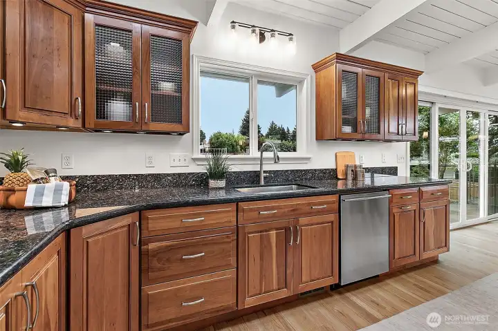 Rich cabinetry and abundant prep space create a warm and functional kitchen.