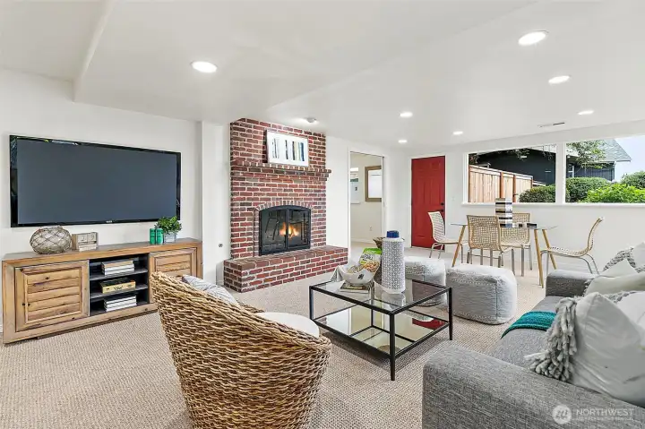 Cozy lower-level living area with fireplace and exterior access.