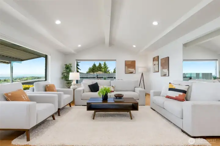 Living area with vaulted ceilings and hardwood floors. Gorgeous view from all main living areas.