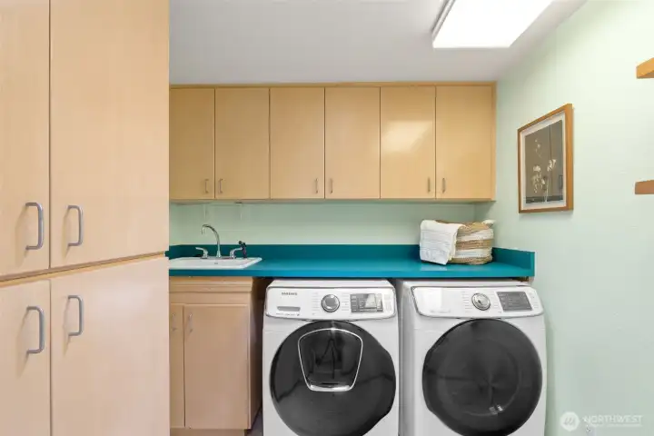 Large laundry room next to the garage. Utility sink and plenty of storage.