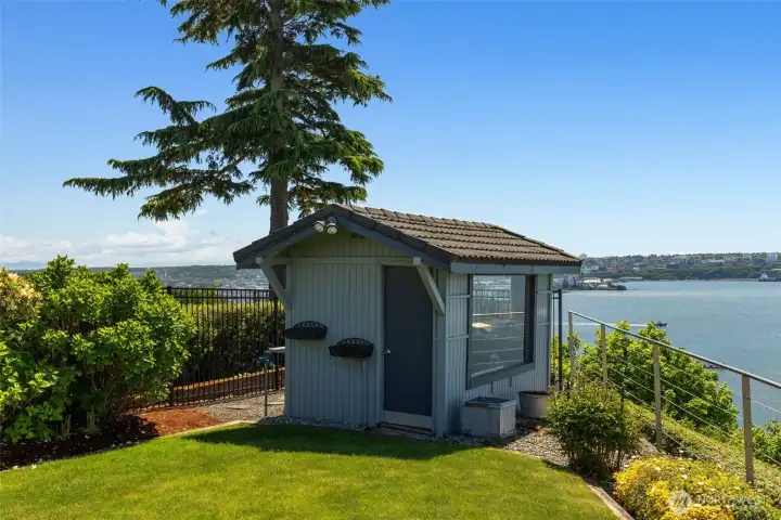 Cute garden shed at corning of back yard.