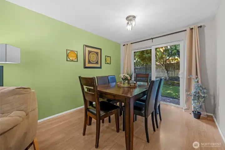 Dining space has a slider to the fully fenced backyard