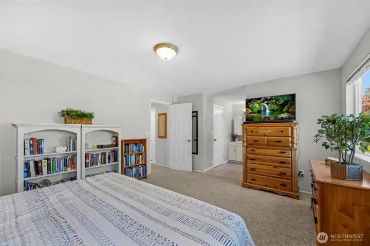 Primary bedroom big enough to store all of your books and still have loads of room