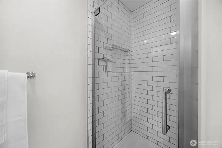 Recently updated tile shower in the primary