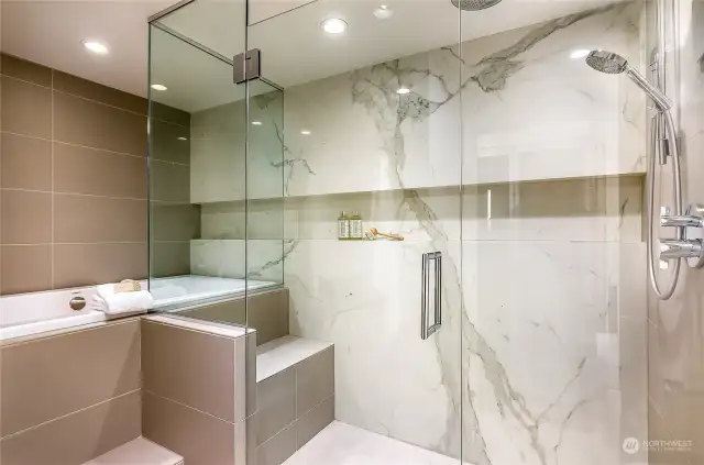 Luxurious primary bathroom inspired by spas, complete with a soaking tub and attached walk-in shower.