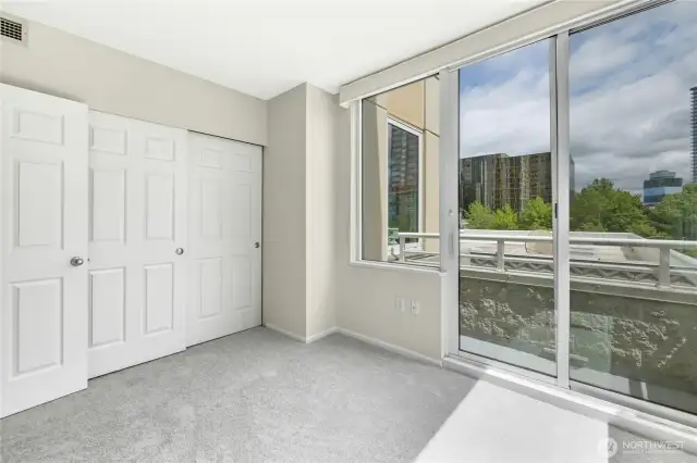 Closet space and balcony view in second bedroom.
