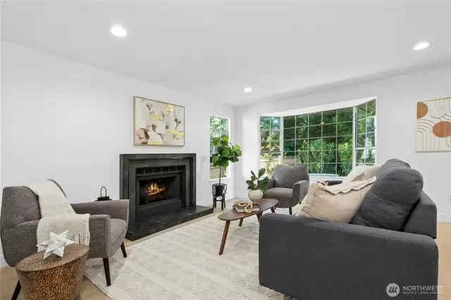 All new flooring, wood-burning fireplace surround, paint and so much more! Lovely natural light too!
