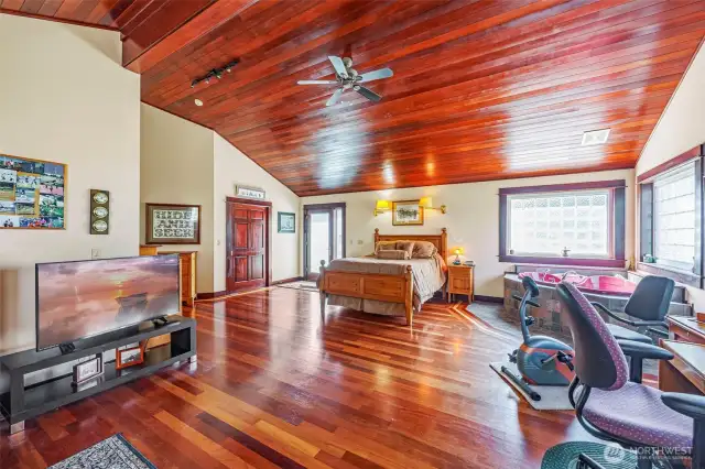 Spacious and versatile! This primary retreat boasts vaulted ceilings, a large walk-in closet, a luxurious jetted tub, plus dedicated office and exercise areas—all designed for comfort and convenience in one stunning space.