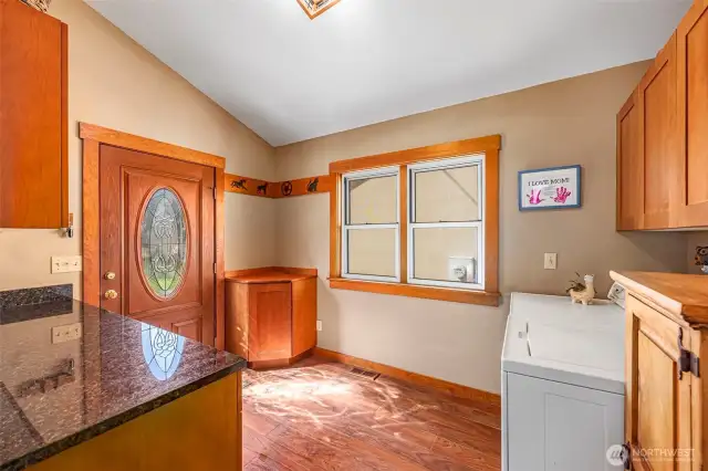 Convenient outside entry from the patio and garage area makes this laundry room a true multitasker. Also serving as a mudroom before entering the kitchen, it offers plenty of cabinets for organized storage.