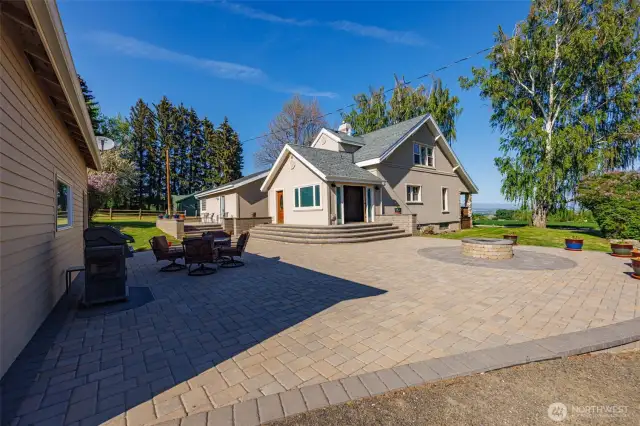 A welcoming outdoor space framed by the home and garage—this spacious paver patio offers plenty of room to relax, entertain, and enjoy serene privacy.