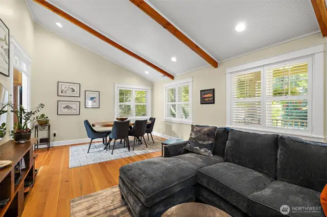 Soaring vaulted ceilings with wood beam accents create a bright an airy atmosphere that enhances the living space.