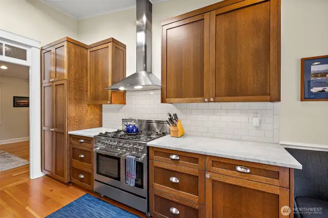 Classic subway tile complements the granite countertops and blends a nice contrast to the rich cabinetry.