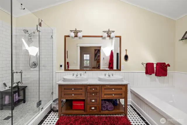 Exquisite spa like primary bath boasts of a custom double sink vanity with handsome fixtures.