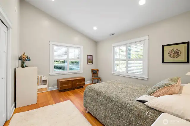 Bedroom two continues with vaulted ceiling and hardwood floors.