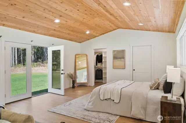 Relax in this expansive primary bedroom with double walk closet with pocket doors. Plenty of privacy looking north out the french doors. And the vaulted tonge and groove feature is yet another amazing detail.
