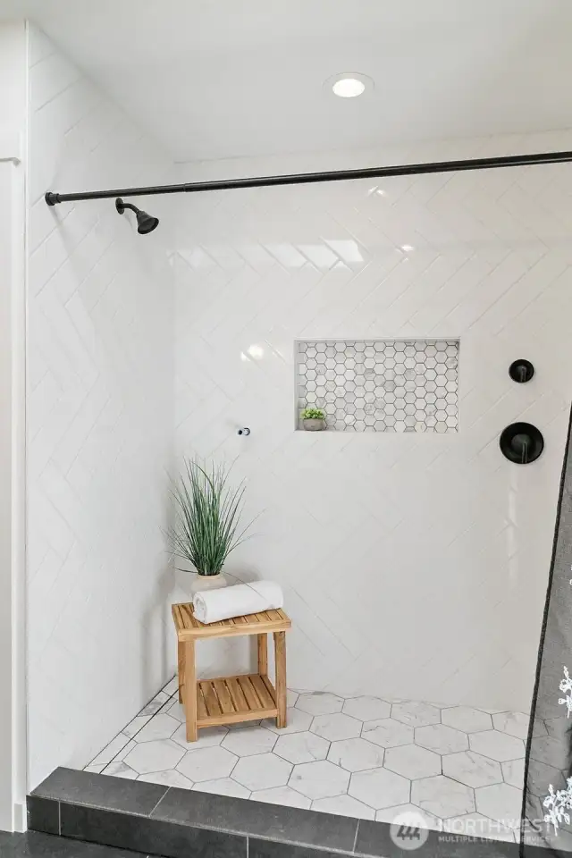 Primary ensuite tastefully tiled shower.