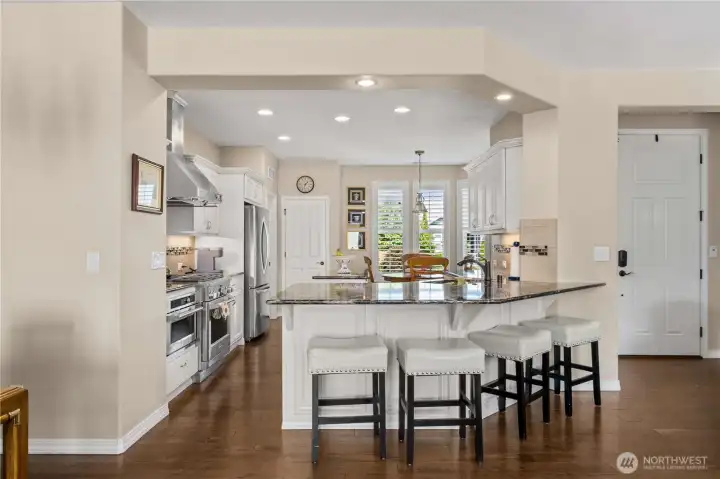 The stunning kitchen boasts of Quartz, top tier appliances, classic white cabinetry and wainscotting.