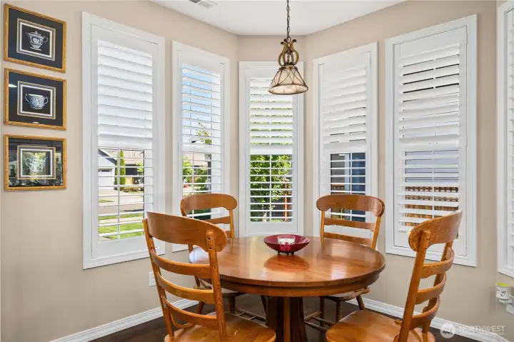 Delightful, light drenched kitchen nook with gorgeous windows and stunning Plantation shutters.