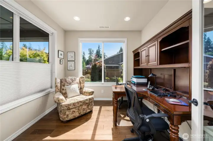 Glass French doors open to the den which enjoys amazing natural light, wrapped windows, Engineered hardwoods and top down/bottom up window shades.