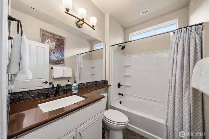 Guest bath/powder room with Quartz counters and tile flooring.