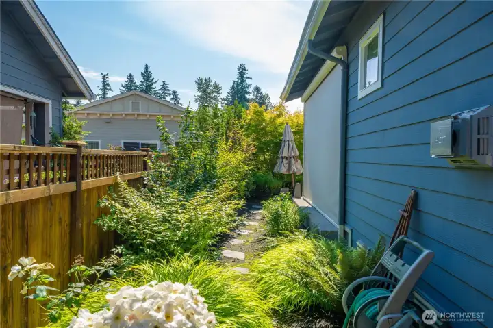 Low maintenance side yard and one of the two motorized privacy screens pictured.