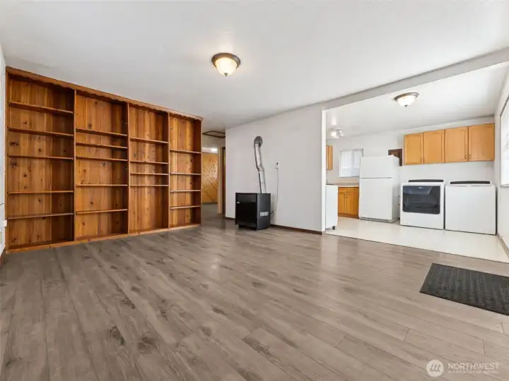 Open floor plan with living/dining/kitchen, custom built in bookshelves and laminate floors.