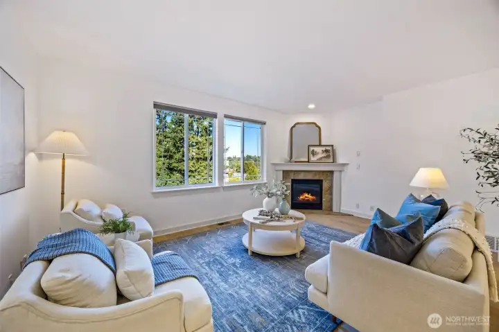 Open main level with gas fireplace, half bath, and covered porch.
