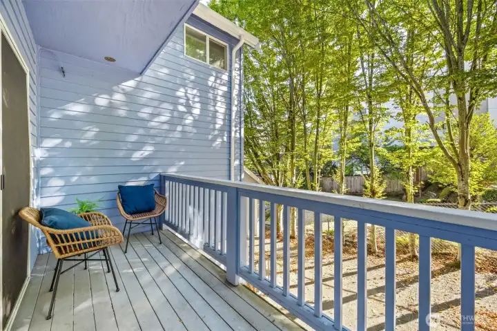 Wonderful covered porch off main level dining area features stairs to the small fenced outdoor space