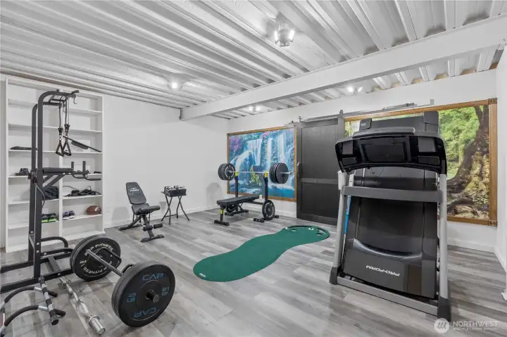 Finished room with storage behind the barn door, perfect home gyms, quilting room, arts and crafts and more!