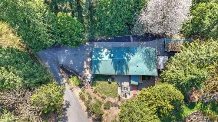Aerial shot showcasing property and metal roof.