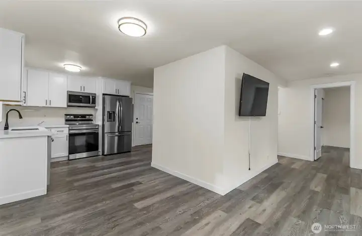 View of the living room, guest bed and kitchen area all from the living space