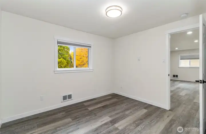 Guest bedroom with a view of the beautiful trees outside