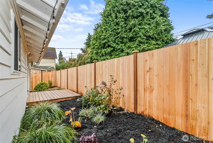 View of the new fence and porch in the cute backyard