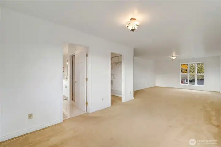 Primary bedroom w/ walk in closet and bathroom