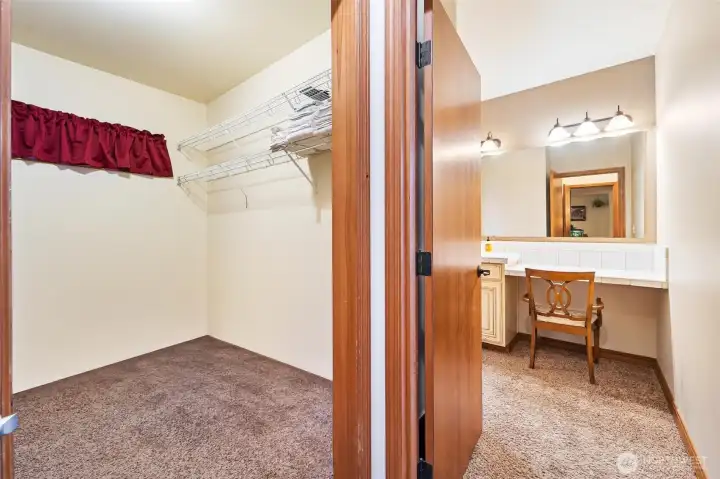 Unit A - Primary bedroom walk in closet and vanity