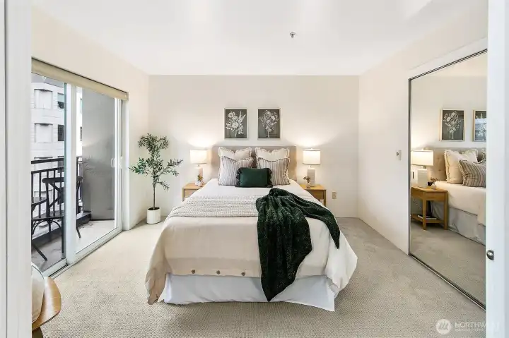 Main floor bedroom with large closet and access to balcony