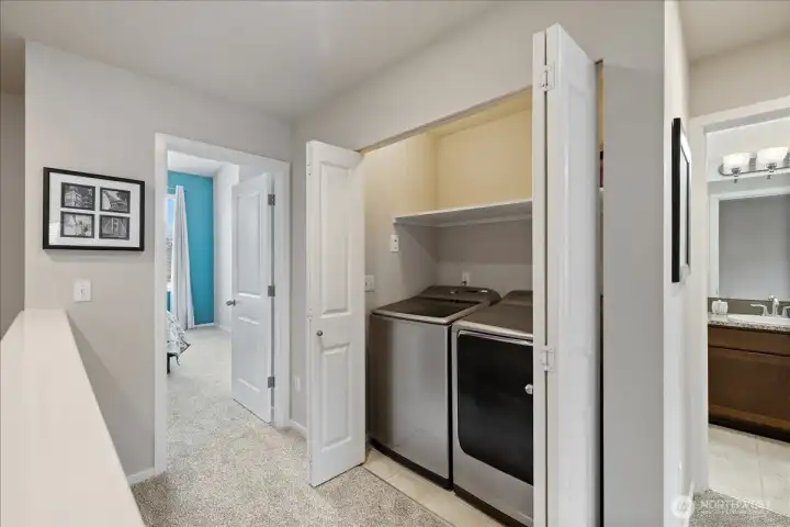 Washer & Dryer next to primary bedroom with bifold doors